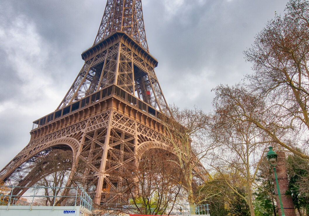 PARIS - DECEMBER 2012: Tourists visit Eiffel Tower. This is the most visited monument in France.